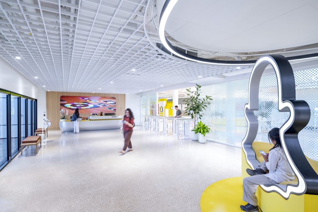 Reception lobby at SNAP Campus with custom reception desk and collaborative workplace interiors.