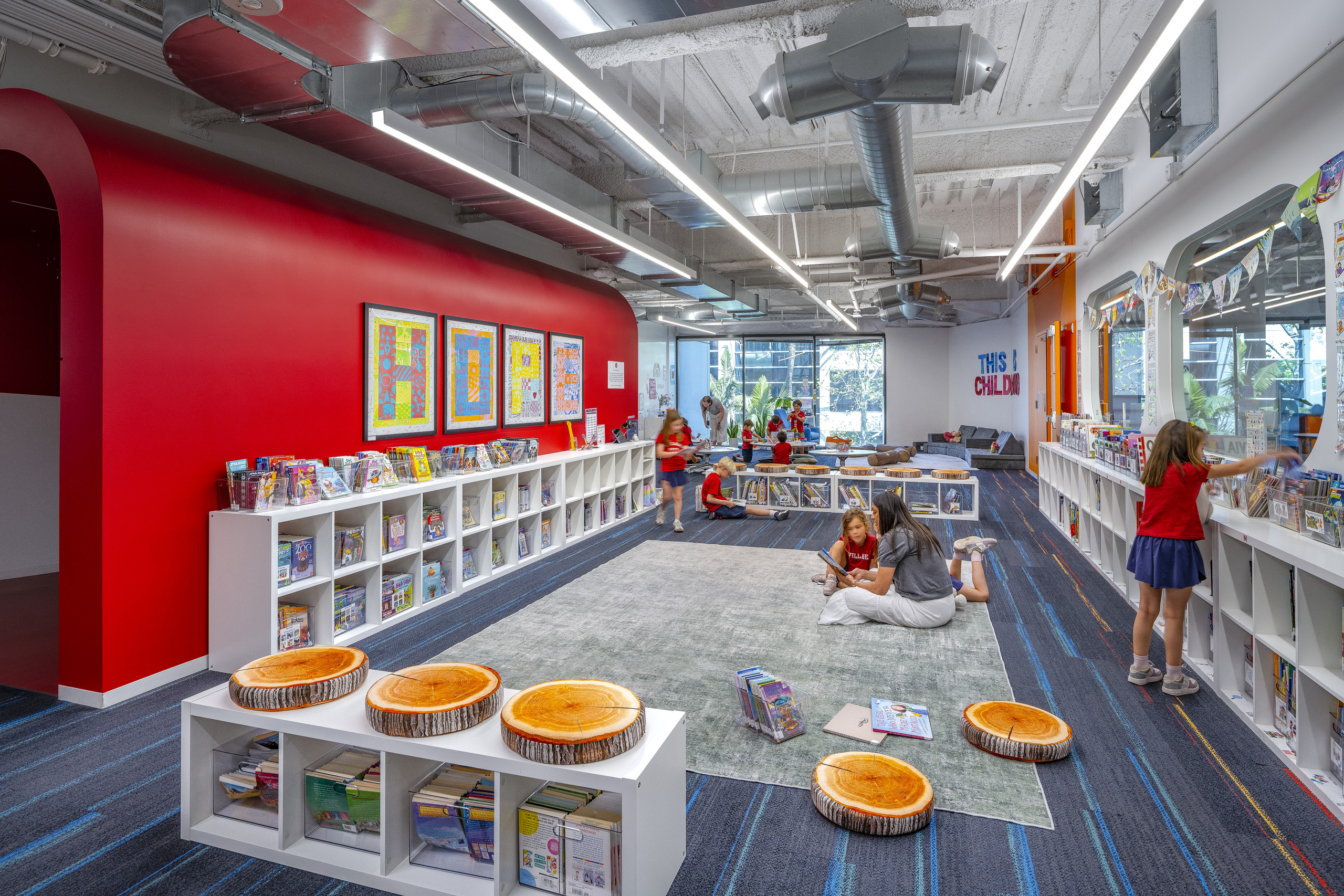 Children reading and browsing books in the colorful Village School library in Santa Monica.