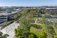 Aerial view of children playing on basketball courts and a landscaped lawn at Village School in Santa Monica.