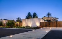 Evening entrance to SNAP Campus Park with sculptural amenity building, custom shade canopies, and landscape lighting.