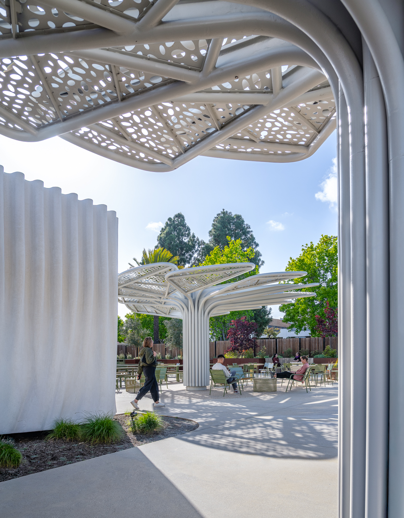 View of the amenity building and custom shade canopies creating outdoor gathering spaces at SNAP Campus Park.
